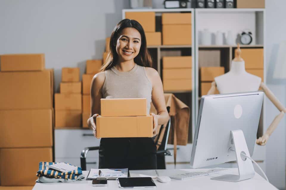 Successful woman start up online seller happy having portable storage at home.