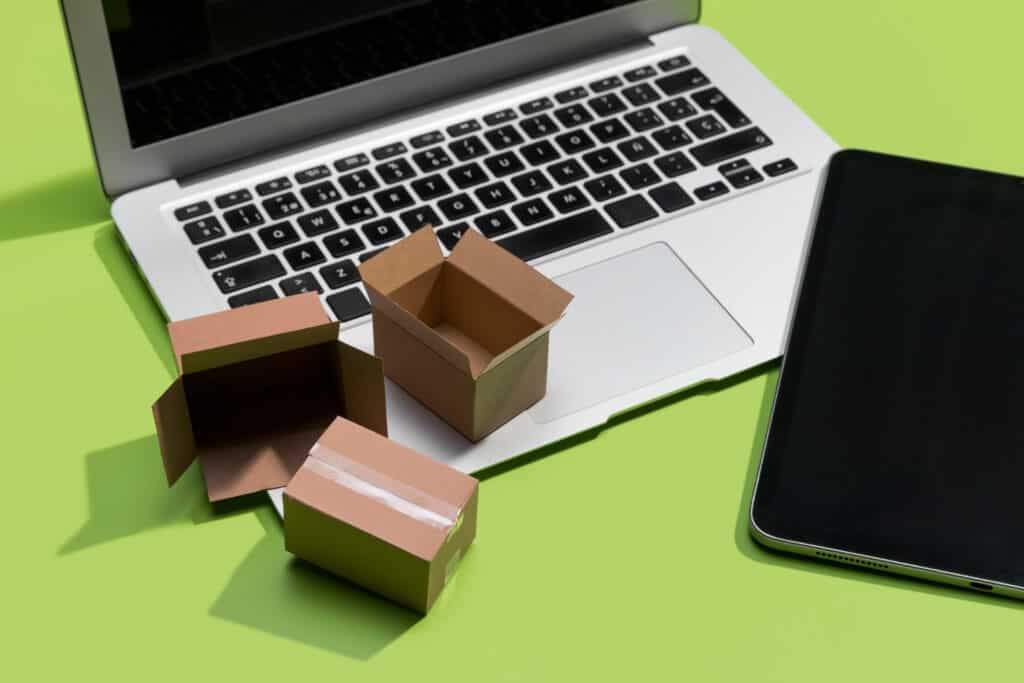 Open boxes on laptop keyboard, green background.