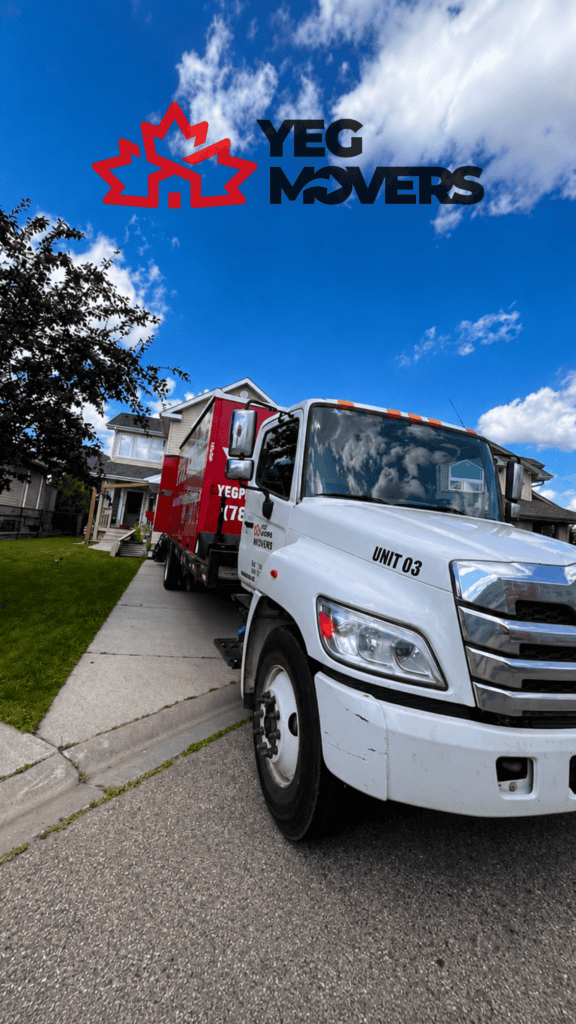 YEG Movers truck parked outside a suburban home