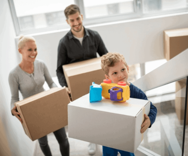 Family carrying boxes up stairs