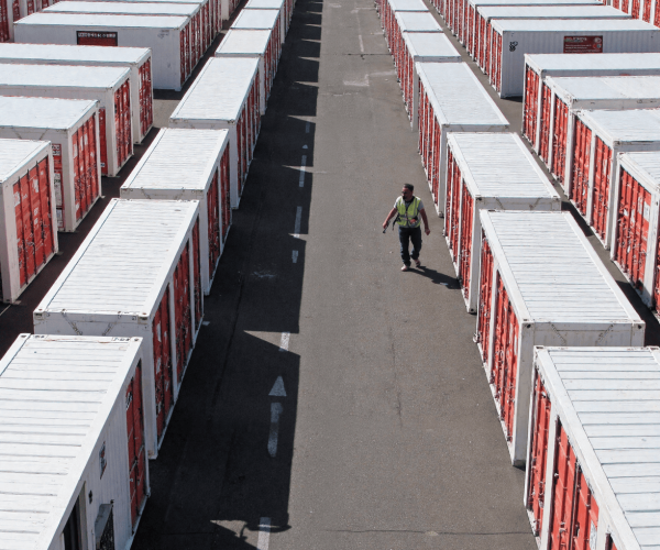 Rows of white storage containers on paved surface.